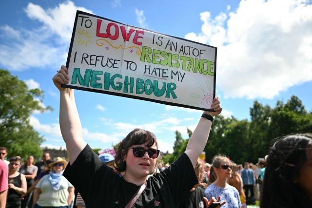 EDITORS NOTE: Graphic content / Protesters display placards as they take part in an anti-racism "Unity March and Rally", organised by Stand up to Racism, Scotland in Edinburgh on June 27, 2026. (Photo by ANDY BUCHANAN / AFP)