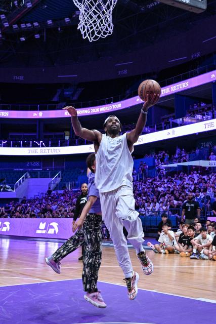 USA's basketball player Kyrie Irving goes for the shot in an event with fans during his World Tour with the Chinese brand ANTA titled "The Return" in Chengdu, in China's southwestern Sichuan province on June 27, 2026. (Photo by Hector RETAMAL / AFP)