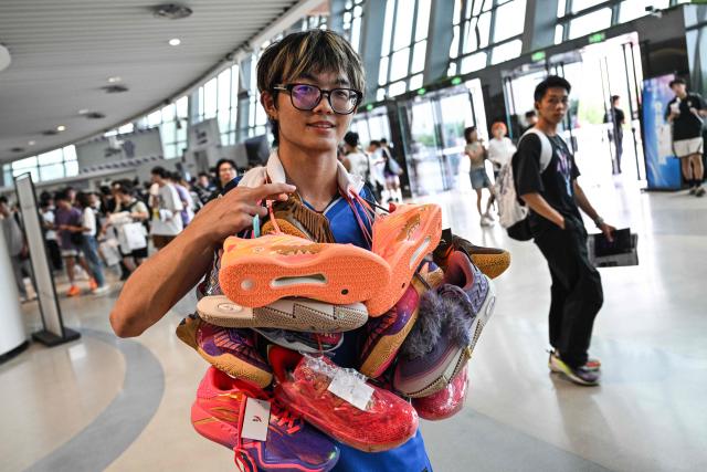 A fan attends an event of USA's basketball player Kyrie Irving of his World Tour with the Chinese brand ANTA titled "The Return" in Chengdu, in China's southwestern Sichuan province on June 27, 2026. (Photo by HECTOR RETAMAL / AFP)