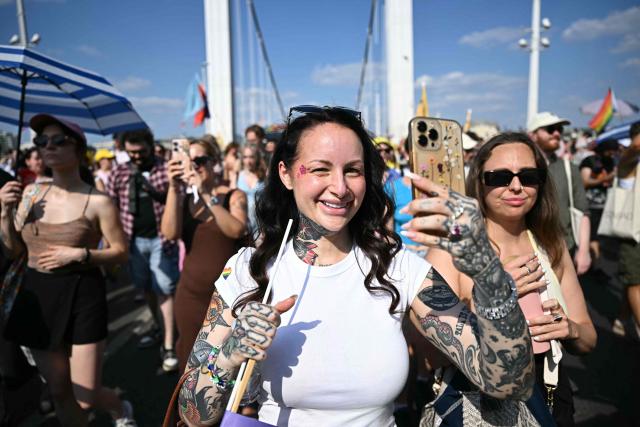 Participants in the Budapest Pride Parade, march across the Elisabeth bridge in Budapest, Hungary on June 27, 2026. (Photo by Attila KISBENEDEK / AFP)