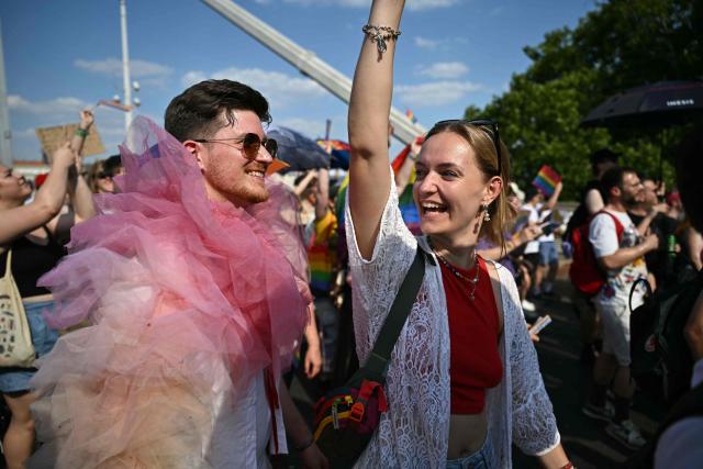 Participants in the Budapest Pride Parade, march across the Elisabeth bridge in Budapest, Hungary on June 27, 2026. (Photo by Attila KISBENEDEK / AFP)