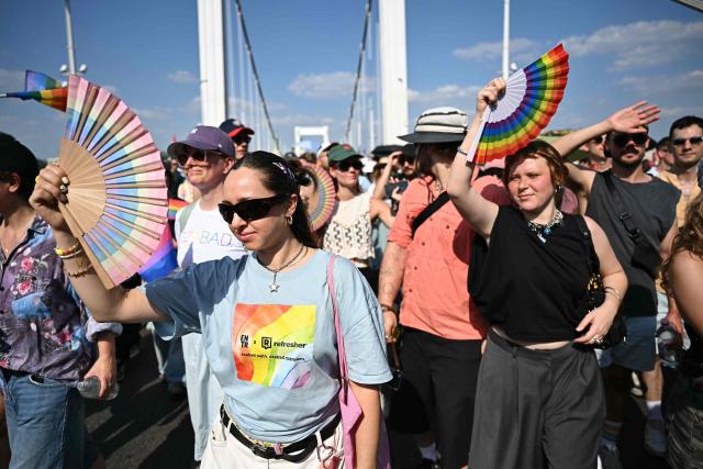 Participants in the Budapest Pride Parade, march across the Elisabeth bridge in Budapest, Hungary on June 27, 2026. (Photo by Attila KISBENEDEK / AFP)