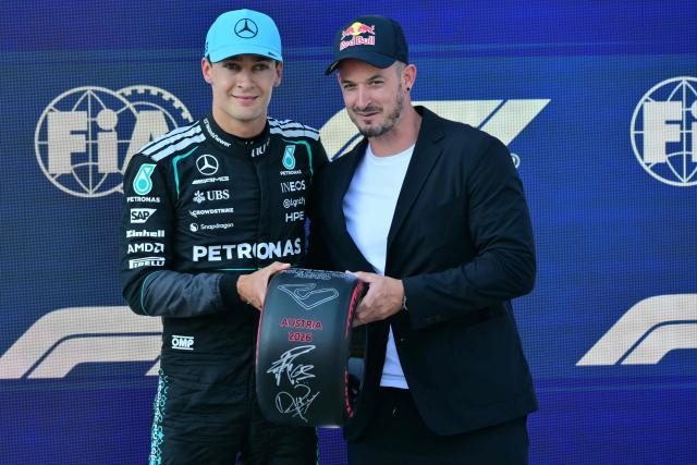 Pole position winner Mercedes' British driver George Russell poses with the pole position award next to Italian alpine skier Dominik Paris after the qualifying session at the Red Bull Ring race track in Spielberg, Austria on June 27, 2026, ahead of the Formula One Austrian Grand Prix. (Photo by Andrej ISAKOVIC / AFP)
