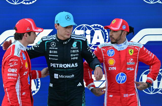 Pole position winner Mercedes' British driver George Russell (C) poses with second placed Ferrari's Monegasque driver Charles Leclerc (L) and third placed Ferrari's British driver Lewis Hamilton (R) after the qualifying session at the Red Bull Ring race track in Spielberg, Austria on June 27, 2026, ahead of the Formula One Austrian Grand Prix. (Photo by Andrej ISAKOVIC / AFP)