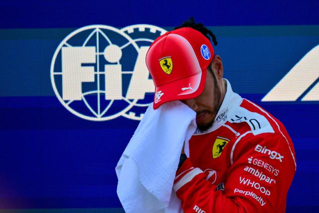 Ferrari's British driver Lewis Hamilton wipes his face with a towel after the qualifying session at the Red Bull Ring race track in Spielberg, Austria on June 27, 2026, ahead of the Formula One Austrian Grand Prix. (Photo by Andrej ISAKOVIC / AFP)