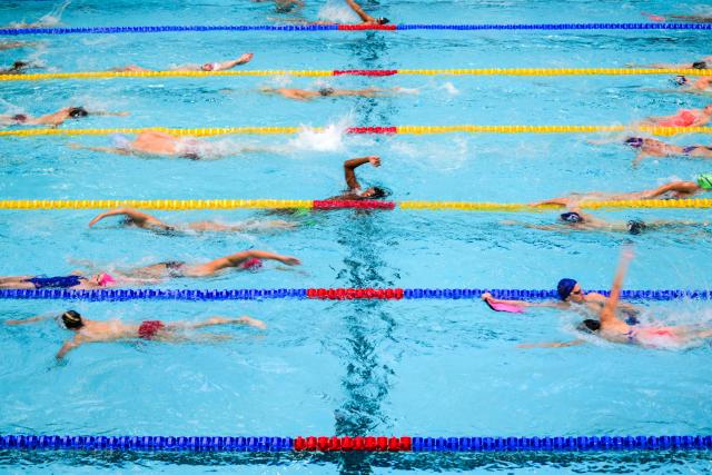 Athletes practice before competing in the French national swimming championships in Saint-Etienne, central France on June 27, 2026. (Photo by OLIVIER CHASSIGNOLE / AFP)