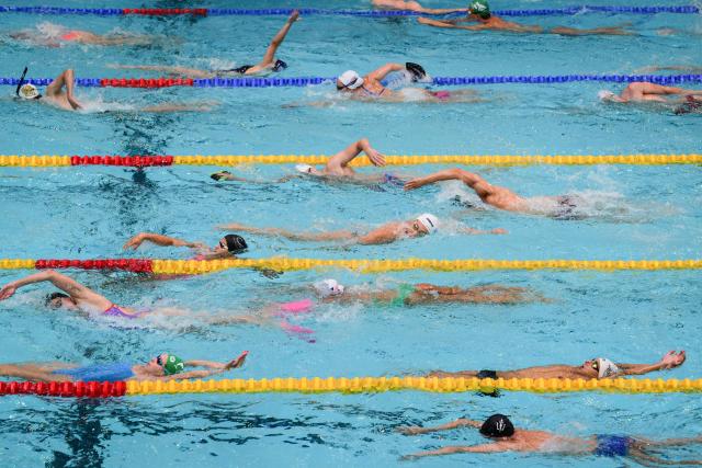 Athletes practice before competing in the French national swimming championships in Saint-Etienne, central France on June 27, 2026. (Photo by OLIVIER CHASSIGNOLE / AFP)