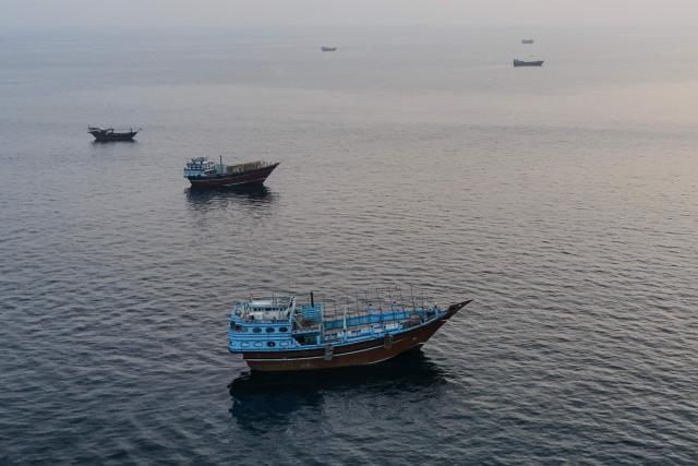 This aerial photograph shows boats anchored off Oman’s northern Musandam Peninsula near the Strait of Hormuz on June 27, 2026. Iran launched attacks on US sites in the Gulf in response to American strikes on the country, state media said on June 27, after Washington accused Tehran of attacking one of its cargo ships in the Strait of Hormuz. The trading of fire raised questions about efforts to keep the crucial waterway open while Washington and Tehran negotiate a final settlement to a war that began on February 28 with US and Israeli strikes on Iran. (Photo by AFP) / 