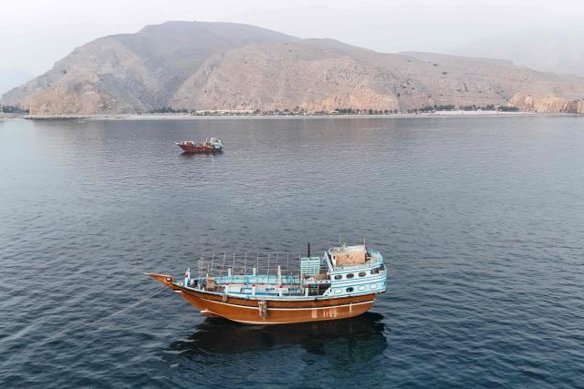 This aerial photograph shows boats anchored off Oman’s northern Musandam Peninsula near the Strait of Hormuz on June 27, 2026. Iran launched attacks on US sites in the Gulf in response to American strikes on the country, state media said on June 27, after Washington accused Tehran of attacking one of its cargo ships in the Strait of Hormuz. The trading of fire raised questions about efforts to keep the crucial waterway open while Washington and Tehran negotiate a final settlement to a war that began on February 28 with US and Israeli strikes on Iran. (Photo by AFP) / 