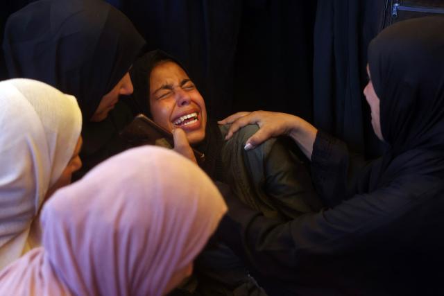 Women mourn over the bodies of 15-year-old Islam Moussa and her brother Abdallah, who were both reportedly killed in an Israeli airstrike, during their funeral in Khan Yunis in the souhthern Gaza Strip on June 27, 2026. A ceasefire has been in place in Gaza since October, but Israel reserves the right to strike targets it deems a threat. The territory remains gripped by daily violence as Israeli strikes continue, with both the military and Hamas accusing one another of violating the truce. (Photo by Bashar Taleb / AFP)