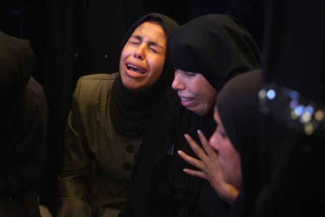 Women mourn over the bodies of 15-year-old Islam Moussa and her brother Abdallah, who were both reportedly killed in an Israeli airstrike, during their funeral in Khan Yunis in the souhthern Gaza Strip on June 27, 2026. A ceasefire has been in place in Gaza since October, but Israel reserves the right to strike targets it deems a threat. The territory remains gripped by daily violence as Israeli strikes continue, with both the military and Hamas accusing one another of violating the truce. (Photo by Bashar Taleb / AFP)