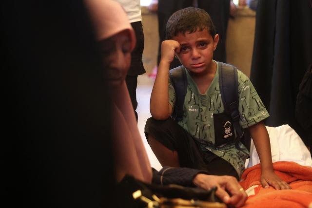 A boy reacts as mourners attend the funeral of 15-year-old Islam Moussa and her brother Abdallah, who were both reportedly killed in an Israeli airstrike, in Khan Yunis in the souhthern Gaza Strip on June 27, 2026. A ceasefire has been in place in Gaza since October, but Israel reserves the right to strike targets it deems a threat. The territory remains gripped by daily violence as Israeli strikes continue, with both the military and Hamas accusing one another of violating the truce. (Photo by Bashar Taleb / AFP)