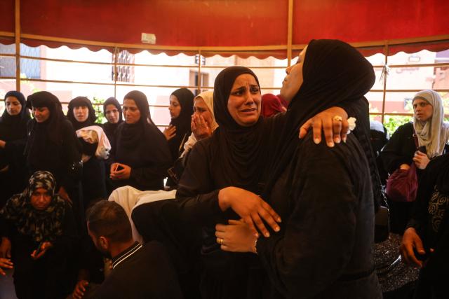 Mourners attend the funeral of 15-year-old Islam Moussa and her brother Abdallah, who were both reportedly killed in an Israeli airstrike, in Khan Yunis in the souhthern Gaza Strip on June 27, 2026. A ceasefire has been in place in Gaza since October, but Israel reserves the right to strike targets it deems a threat. The territory remains gripped by daily violence as Israeli strikes continue, with both the military and Hamas accusing one another of violating the truce. (Photo by Bashar Taleb / AFP)