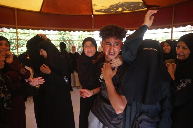 Mourners attend the funeral of 15-year-old Islam Moussa and her brother Abdallah, who were both reportedly killed in an Israeli airstrike, in Khan Yunis in the souhthern Gaza Strip on June 27, 2026. A ceasefire has been in place in Gaza since October, but Israel reserves the right to strike targets it deems a threat. The territory remains gripped by daily violence as Israeli strikes continue, with both the military and Hamas accusing one another of violating the truce. (Photo by Bashar Taleb / AFP)