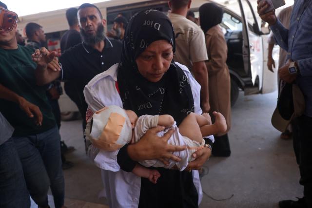 A Palestinian nurse carries an injured child at Nasser Hospital in Khan Yunis in the southern Gaza Strip, following a reported Israeli strike on a displacement camp in Al-Mawasi, on June 27, 2026. A ceasefire has been in place in Gaza since October, but Israel reserves the right to strike targets it deems a threat. The territory remains gripped by daily violence as Israeli strikes continue, with both the military and Hamas accusing one another of violating the truce. (Photo by Bashar Taleb / AFP)