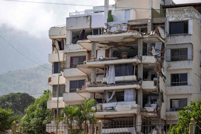 A partially collapsed building is seen from the base camp of the French Civil Security Training and Intervention Regiment (UIISC 7) at the Karting La Guaira complex in Caraballeda, La Guaira state, Venezuela, on June 27, 2026, as they assist with rescue operations following earthquakes. Nearly 1,000 people have been killed and more than 50,000 remain missing after two consecutive earthquakes in Venezuela, where growing anger has been reported over the lack of official aid to swiftly rescue survivors. (Photo by Miguel MEDINA / POOL / AFP)