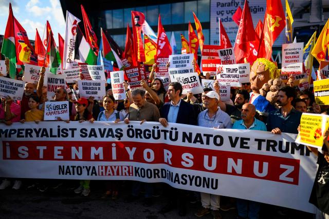 Protesters hold banners, flags and placard during a leftist anti-NATO demonstration in Istanbul, ahead of the NATO summit Ankara on June 27, 2026. (Photo by Yasin AKGUL / AFP)