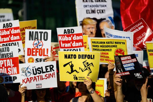 Protesters hold placard during a leftist anti-NATO demonstration in Istanbul, ahead of the NATO summit Ankara on June 27, 2026. The NATO summit takes place in Ankara on July 7-8. (Photo by Yasin AKGUL / AFP)