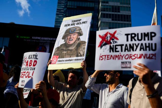 A protester holds a placard featuring US President Donald Trump during a leftist anti-NATO demonstration in Istanbul, ahead of the NATO summit in Ankara on June 27, 2026. The NATO summit takes place in Ankara on July 7-8. (Photo by Yasin AKGUL / AFP)
