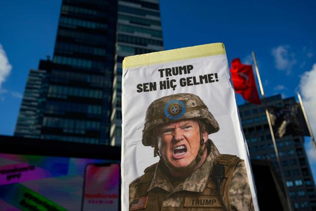 A protester holds a placard featuring US President Donald Trump during a leftist anti-NATO demonstration in Istanbul, ahead of the NATO summit in Ankara on June 27, 2026. The NATO summit takes place in Ankara on July 7-8. (Photo by Yasin AKGUL / AFP)