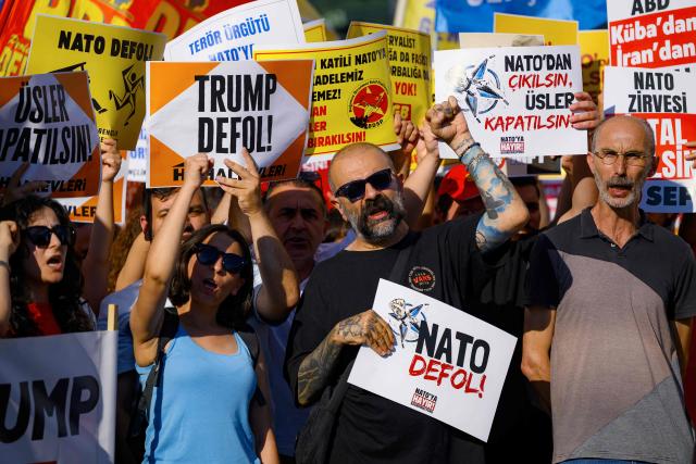 Protesters hold placard during a leftist anti-NATO demonstration in Istanbul, ahead of the NATO summit Ankara on June 27, 2026. The NATO summit takes place in Ankara on July 7-8. (Photo by Yasin AKGUL / AFP)