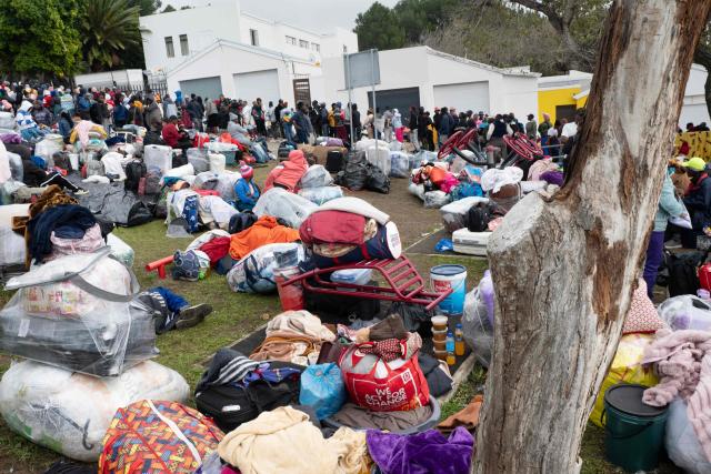 Hundreds of Zimbabwean migrants gather with their belongings outside the Zimbabwean Consulate in Cape Town, on June 27, 2026, as they try to get repatriated to Zimbabwe. South Africans President Cyril Ramaphosa vowed on Thursday to crush any attempts to destabilise the nation during planned anti-immigrant marches next week, amid a wave of xenophobia. Citizen-led groups have set Tuesday 30 as a deadline for undocumented foreigners to leave and called for nationwide marches against illegal immigration, marking a crescendo in months of protests that have at times turned violent. (Photo by RODGER BOSCH / AFP)