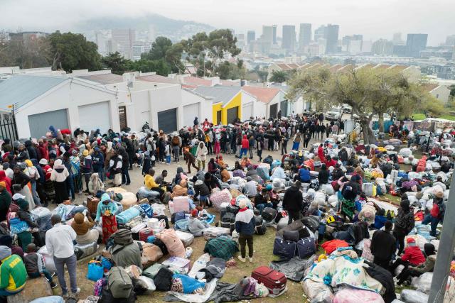 Hundreds of Zimbabwean migrants gather with their belongings outside the Zimbabwean Consulate in Cape Town, on June 27, 2026, as they try to get repatriated to Zimbabwe. South Africans President Cyril Ramaphosa vowed on Thursday to crush any attempts to destabilise the nation during planned anti-immigrant marches next week, amid a wave of xenophobia. Citizen-led groups have set Tuesday 30 as a deadline for undocumented foreigners to leave and called for nationwide marches against illegal immigration, marking a crescendo in months of protests that have at times turned violent. (Photo by RODGER BOSCH / AFP)