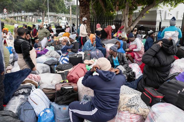 Hundreds of Zimbabwean migrants gather with their belongings outside the Zimbabwean Consulate in Cape Town, on June 27, 2026, as they try to get repatriated to Zimbabwe. South Africans President Cyril Ramaphosa vowed on Thursday to crush any attempts to destabilise the nation during planned anti-immigrant marches next week, amid a wave of xenophobia. Citizen-led groups have set Tuesday 30 as a deadline for undocumented foreigners to leave and called for nationwide marches against illegal immigration, marking a crescendo in months of protests that have at times turned violent. (Photo by RODGER BOSCH / AFP)