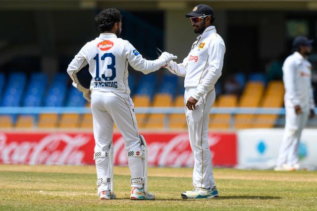 Kusal Mendis (L) and Dhananjaya de Silva (R) of Sri Lanka confer during the 3rd day of the 1st Test between Sri Lanka and West Indies at Vivian Richards Cricket Stadium in North Sound, Antigua and Barbuda, on June 27, 2026. (Photo by Randy Brooks / AFP)