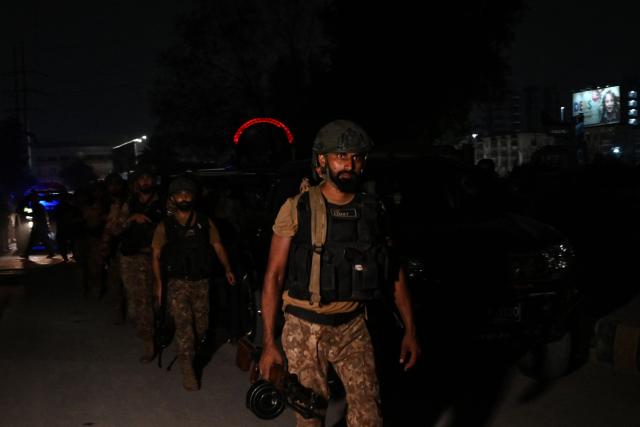 Army soldiers arrive to cordon off the streets around the Mosamiat Chowrangi area after a militant attack on Pakistand Security Rangers compound in Karachi on June 27, 2026. Heavy gunfire was heard in Pakistan's southern megacity Karachi on June 27 evening, according to AFP journalists, following reports of an explosion. (Photo by Asif HASSAN / AFP)