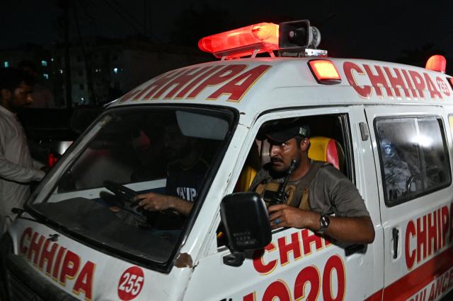 An ambulance carrying the body of a victim leaves the site after a militant attack on Pakistan's Security Rangers compound in Karachi on June 27, 2026. Heavy gunfire was heard in Pakistan's southern megacity Karachi on June 27 evening, according to AFP journalists, following reports of an explosion. (Photo by Asif HASSAN / AFP)