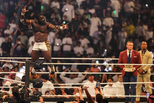 Nigerian wrestler Oba Femi celebrates while standing on the ring ropes during the WWE Night of Champions wrestling event in Riyadh on June 27, 2026. (Photo by Fayez NURELDINE / AFP)