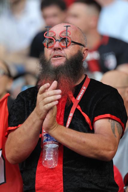 A Stade Toulousain's supporter cheers his team prior to the French Top 14 rugby union final between Stade Toulousain (Toulouse) and Montpellier Hérault Rugby (MHR) at the Stade de France in Saint-Denis, on the outskirst of Paris, on June 27, 2026. (Photo by Kenzo TRIBOUILLARD / AFP)