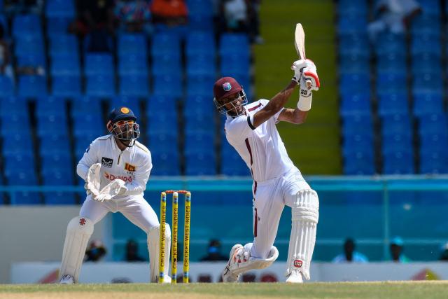 Roston Chase (R) of West Indies hits 6 and Kusal Mendis (L) of Sri Lanka looks on during the 3rd day of the 1st Test between Sri Lanka and West Indies at Vivian Richards Cricket Stadium in North Sound, Antigua and Barbuda, on June 27, 2026. (Photo by Randy Brooks / AFP)