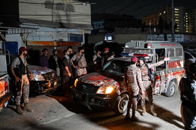 Paramilitary soldiers arrive to cordon off the streets around the Mosamiat Chowrangi area after a militant attack on Pakistan's Security Rangers compound in Karachi on June 27, 2026. Heavy gunfire was heard in Pakistan's southern megacity Karachi on June 27 evening, according to AFP journalists, following reports of an explosion. (Photo by Asif HASSAN / AFP)