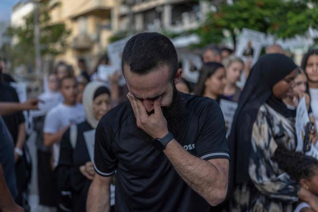 A relative mourns during a memorial vigil marking the killing of Arab-Israli teenager Ahmad Jabari in Jaffa on June 27, 2026. Jabari was shot on June 25 by an unidentified man on a scooter while he was working in a local supermarket, according to Israeli police. Another teenager was injured in the incident. (Photo by ilia YEFIMOVICH / AFP)