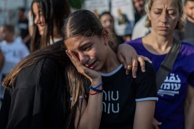 Relatives mourn during a memorial vigil marking the killing of Arab-Israli teenager Ahmad Jabari in Jaffa on June 27, 2026. Jabari was shot on June 25 by an unidentified man on a scooter while he was working in a local supermarket, according to Israeli police. Another teenager was injured in the incident. (Photo by ilia YEFIMOVICH / AFP)