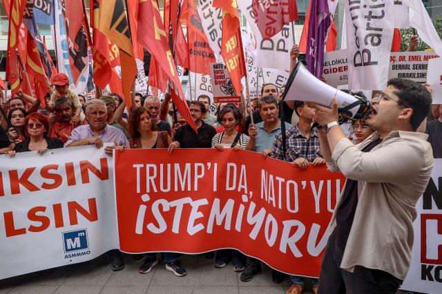 Protesters hold a banner reading "We do not want Trump and we do not want NATO either" as they chant slogans against NATO during an anti-NATO demonstration in Ankara, on June 27, 2026 ahead of the NATO summit. The NATO summit will take place in Ankara on July 7-8 and is expected to be attended by 32 leaders including US President. (Photo by ADEM ALTAN / AFP)