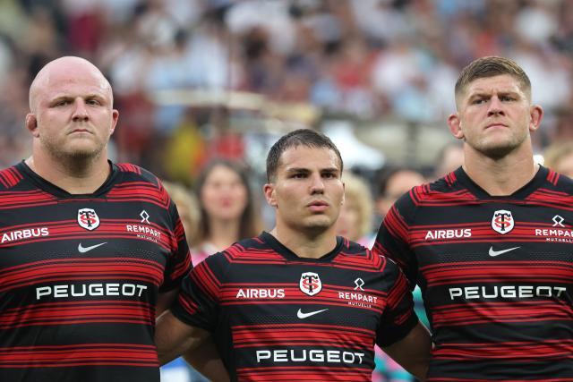 (From L) Toulouse's Spanish prop Joel Merkler, Toulouse's French scrum-half Antoine Dupont and Toulouse's English flanker Jack Willis stand on the picth prior to the French Top 14 rugby union final between Stade Toulousain (Toulouse) and Montpellier Hérault Rugby (MHR) at the Stade de France in Saint-Denis, on the outskirst of Paris, on June 27, 2026. (Photo by Kenzo TRIBOUILLARD / AFP)