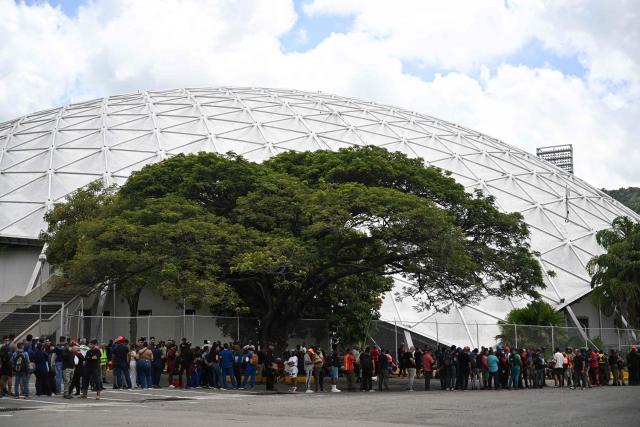 Volunteers queue to request permission to travel to La Guaira state to assist with rescue operations following earthquakes at the Poliedro in Caracas on June 27, 2026. Nearly 1,000 people have been killed and more than 50,000 remain missing after two consecutive earthquakes in Venezuela, where growing anger has been reported over the lack of official aid to swiftly rescue survivors. (Photo by Juan BARRETO / AFP)