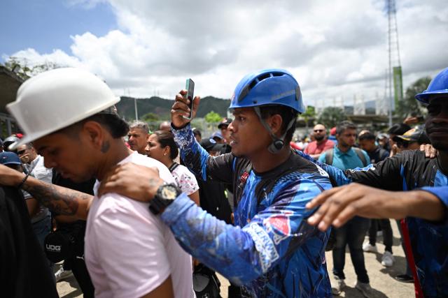 Volunteers queue to request permission to travel to La Guaira state to assist with rescue operations following earthquakes at the Poliedro in Caracas on June 27, 2026. Nearly 1,000 people have been killed and more than 50,000 remain missing after two consecutive earthquakes in Venezuela, where growing anger has been reported over the lack of official aid to swiftly rescue survivors. (Photo by Juan BARRETO / AFP)