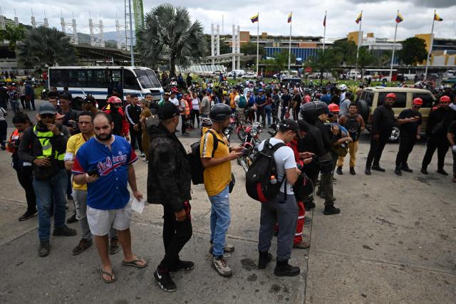 Volunteers queue to request permission to travel to La Guaira state to assist with rescue operations following earthquakes at the Poliedro in Caracas on June 27, 2026. Nearly 1,000 people have been killed and more than 50,000 remain missing after two consecutive earthquakes in Venezuela, where growing anger has been reported over the lack of official aid to swiftly rescue survivors. (Photo by Juan BARRETO / AFP)