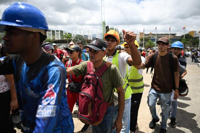 Volunteers queue to request permission to travel to La Guaira state to assist with rescue operations following earthquakes at the Poliedro in Caracas on June 27, 2026. Nearly 1,000 people have been killed and more than 50,000 remain missing after two consecutive earthquakes in Venezuela, where growing anger has been reported over the lack of official aid to swiftly rescue survivors. (Photo by Juan BARRETO / AFP)