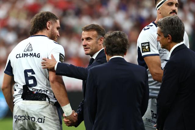 France's President Emmanuel Macron greets Montpellier’s French flanker Lenni Nouchi (L) prior to the French Top 14 rugby union final between Stade Toulousain (Toulouse) and Montpellier Hйrault Rugby (MHR) at the Stade de France in Saint-Denis, on the outskirst of Paris, on June 27, 2026. (Photo by Anne-Christine POUJOULAT / AFP)