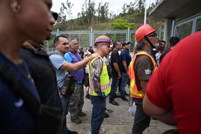 Volunteers queue to request permission to travel to La Guaira state to assist with rescue operations following earthquakes at the Poliedro in Caracas on June 27, 2026. Nearly 1,000 people have been killed and more than 50,000 remain missing after two consecutive earthquakes in Venezuela, where growing anger has been reported over the lack of official aid to swiftly rescue survivors. (Photo by Juan BARRETO / AFP)