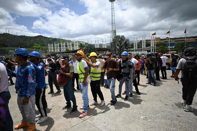 Volunteers queue to request permission to travel to La Guaira state to assist with rescue operations following earthquakes at the Poliedro in Caracas on June 27, 2026. Nearly 1,000 people have been killed and more than 50,000 remain missing after two consecutive earthquakes in Venezuela, where growing anger has been reported over the lack of official aid to swiftly rescue survivors. (Photo by Juan BARRETO / AFP)