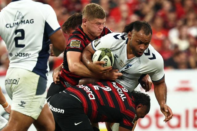 Montpellier’s English  number eight Billy Vunipola is tackled by Toulouse's English flanker Jack Willis (up) and Toulouse's French hooker Peato Mauvaka during the French Top 14 rugby union final between Stade Toulousain (Toulouse) and Montpellier Hйrault Rugby (MHR) at the Stade de France in Saint-Denis, on the outskirst of Paris, on June 27, 2026. (Photo by Anne-Christine POUJOULAT / AFP)