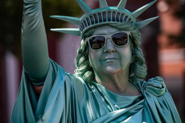 A woman wearing a Statue of Liberty costume participates in the "All of US" demonstration in Portsmouth, New Hampshire, on June 27, 2026. Activists are conducting a nationwide response to the planned events by the administration of US President Donald Trump to mark the 250th anniversary of the United States' Declaration of Independence. (Photo by JOSEPH PREZIOSO / AFP)