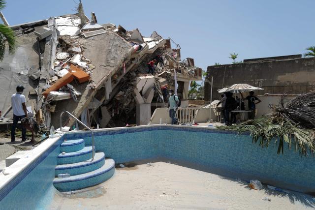 Rescuers work on a collapsed building in Caraballeda, La Guaira state, Venezuela, on June 27, 2026, following earthquakes. Nearly 1,000 people have been killed and more than 50,000 remain missing after two consecutive earthquakes in Venezuela, where growing anger has been reported over the lack of official aid to swiftly rescue survivors. (Photo by Mauricio VALENZUELA / AFP)