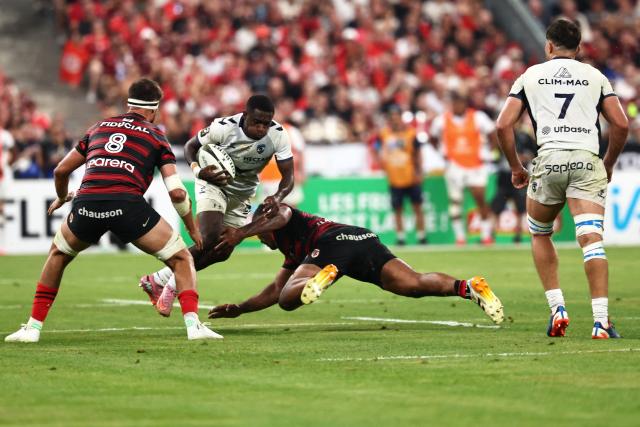 Montpellier’s French wing Gabriel Ngandebe is tackled by Toulouse's French hooker Peato Mauvaka during the French Top 14 rugby union final between Stade Toulousain (Toulouse) and Montpellier Hйrault Rugby (MHR) at the Stade de France in Saint-Denis, on the outskirsts of Paris, on June 27, 2026. (Photo by Anne-Christine POUJOULAT / AFP)